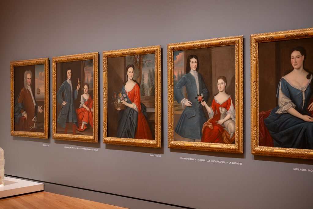Paintings in a museum all in a row. Portraits.