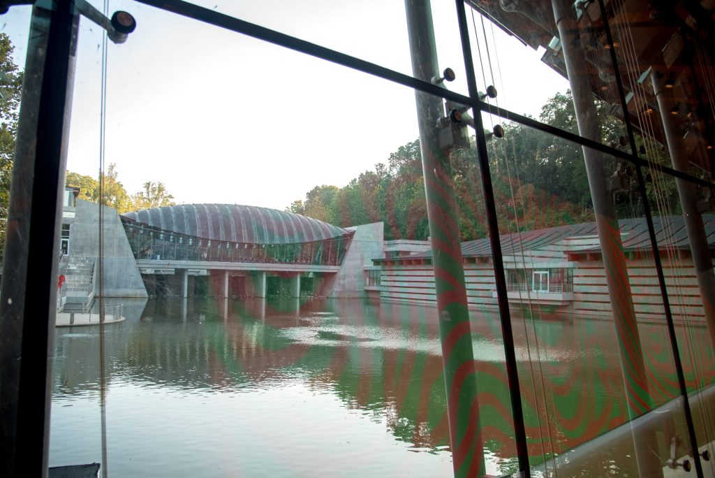 Looking out through a set of windows to a large glass structure.
