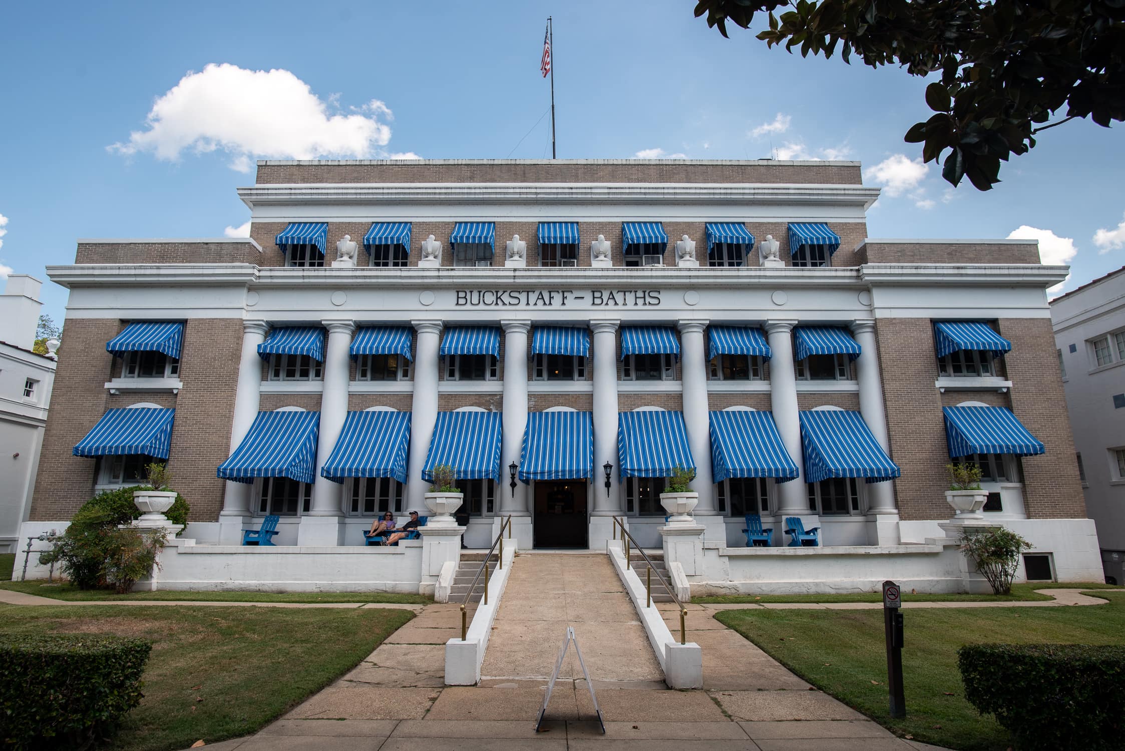 The Buckstaff Bathhouse in the Hot Springs National Park located in southwest Arkansas. The building is brown brick with blue and white striped awnings. Hot Springs National Park is located in the Southwest region of Arkansas.