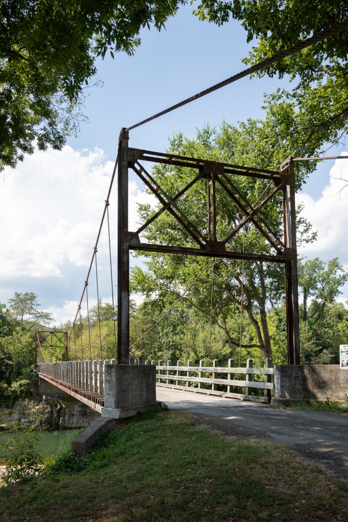 Vertical view of a historic suspension bridge in the Ozark Mountains of Arkansas. 