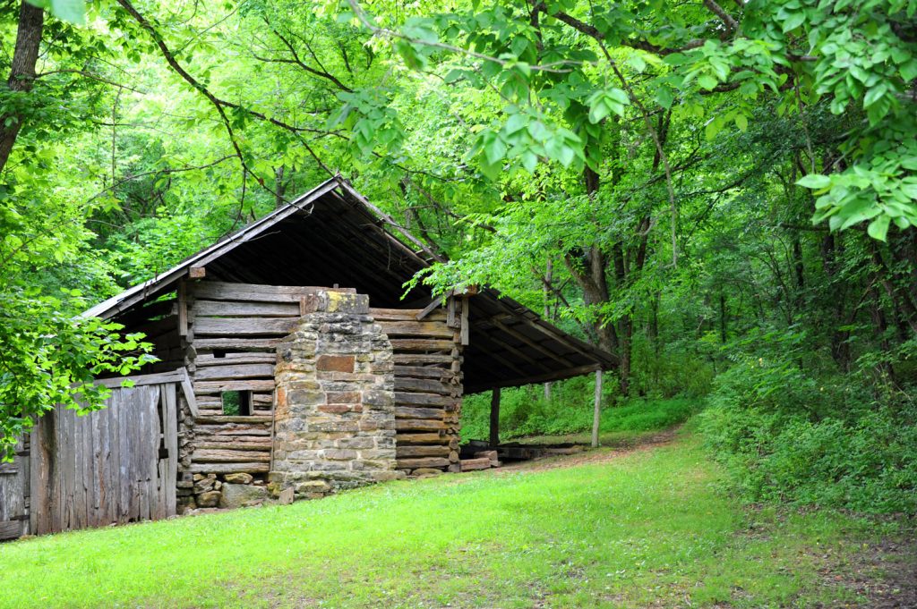 Jim Villines cabin in Northwest Arkansas. This cabin is on a post to represent the cabin that the Arkansas Traveler approached when he was lost in the Ozark Mountains. 