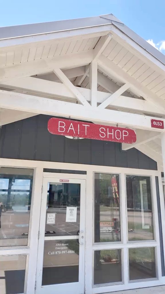 A white building with a sign that says bait shop