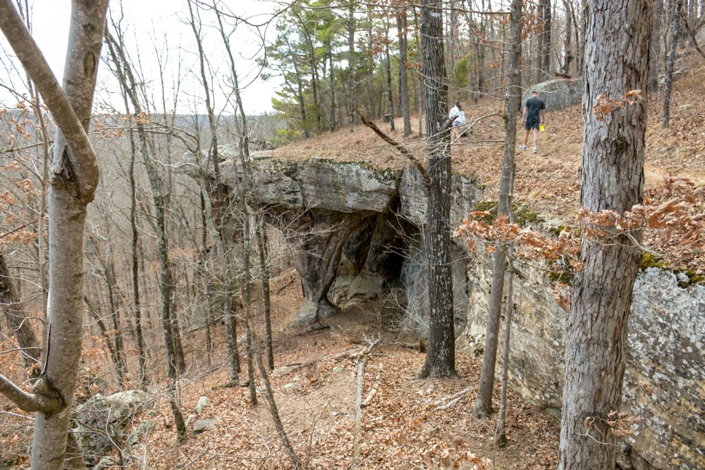 Hiking alongside a high bluff with interesting rock formations. 