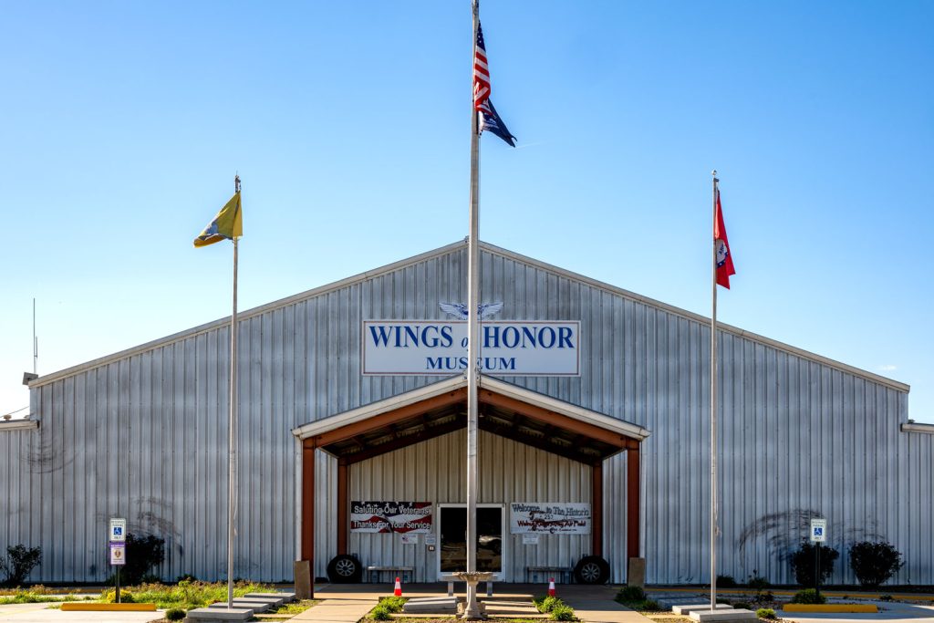 Exterior of a metal building with a sign that says Wings of Honor Museum. This is a museum in Walnut Ridge, Arkansas. 