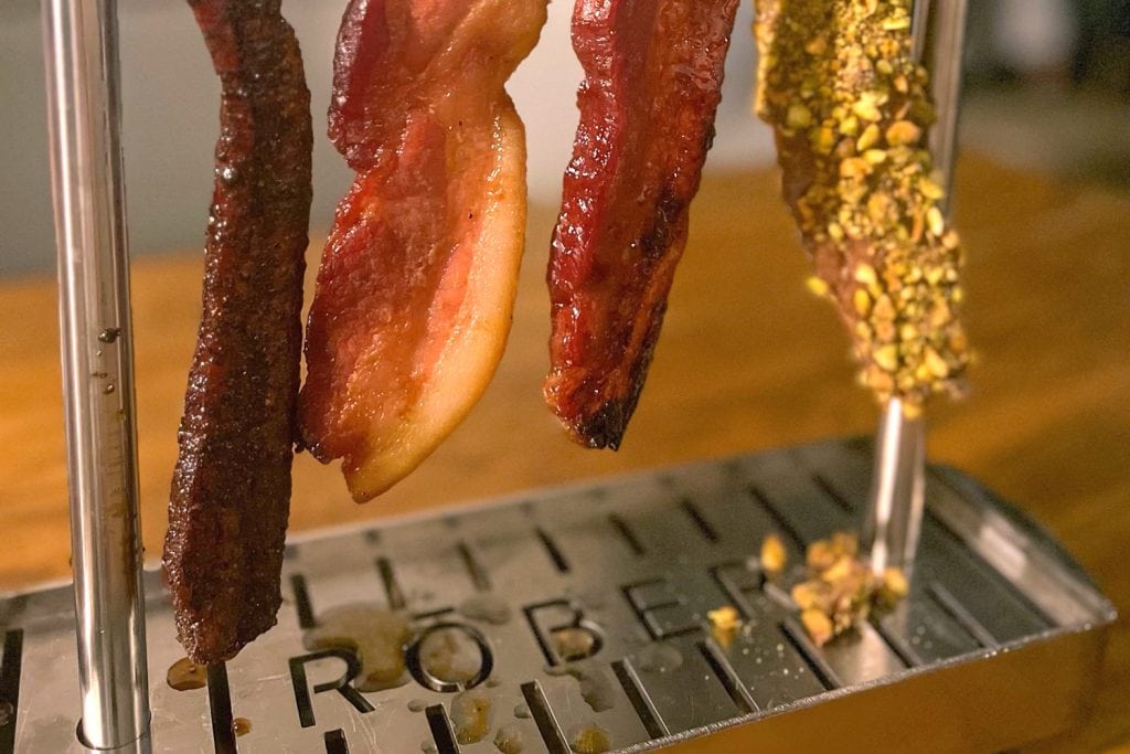 Bacon flight served on a metal rack at RŌBER in Benton, Arkansas.