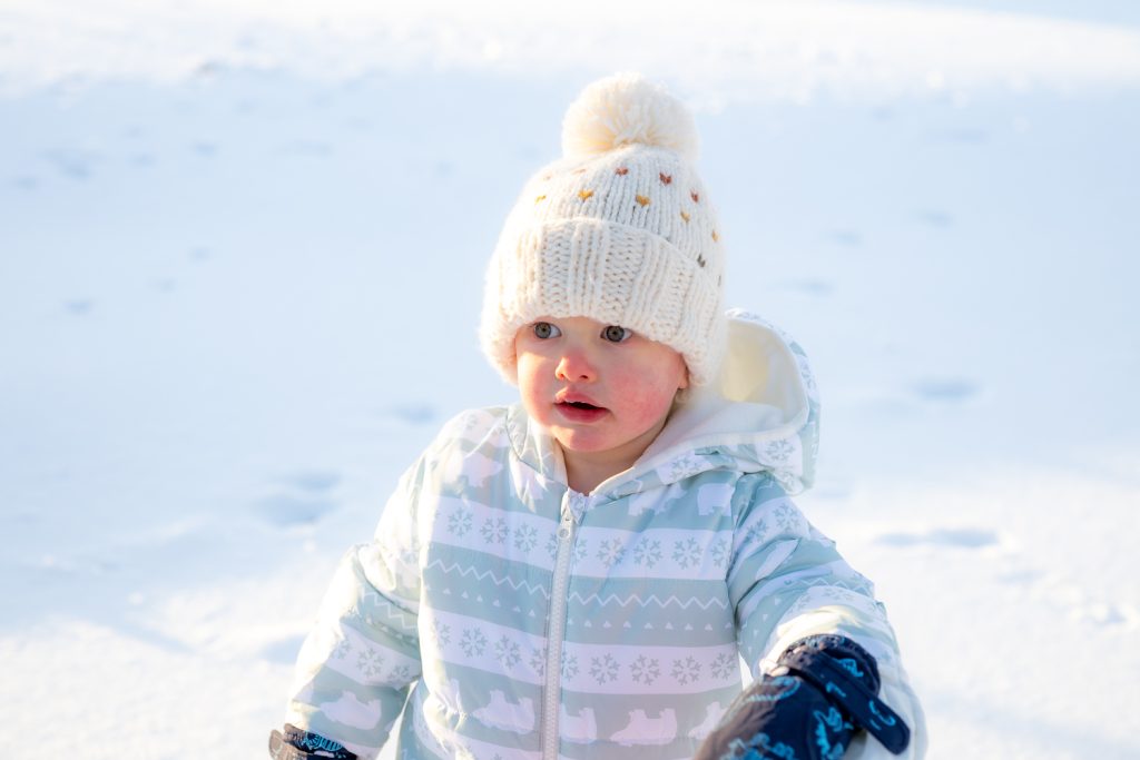 A little boy playing in the snow