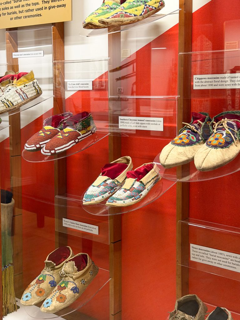 Native American beaded moccasins in a display case.
