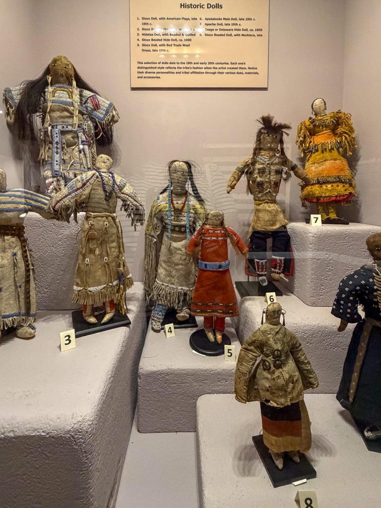 Native American dolls in a display case.
