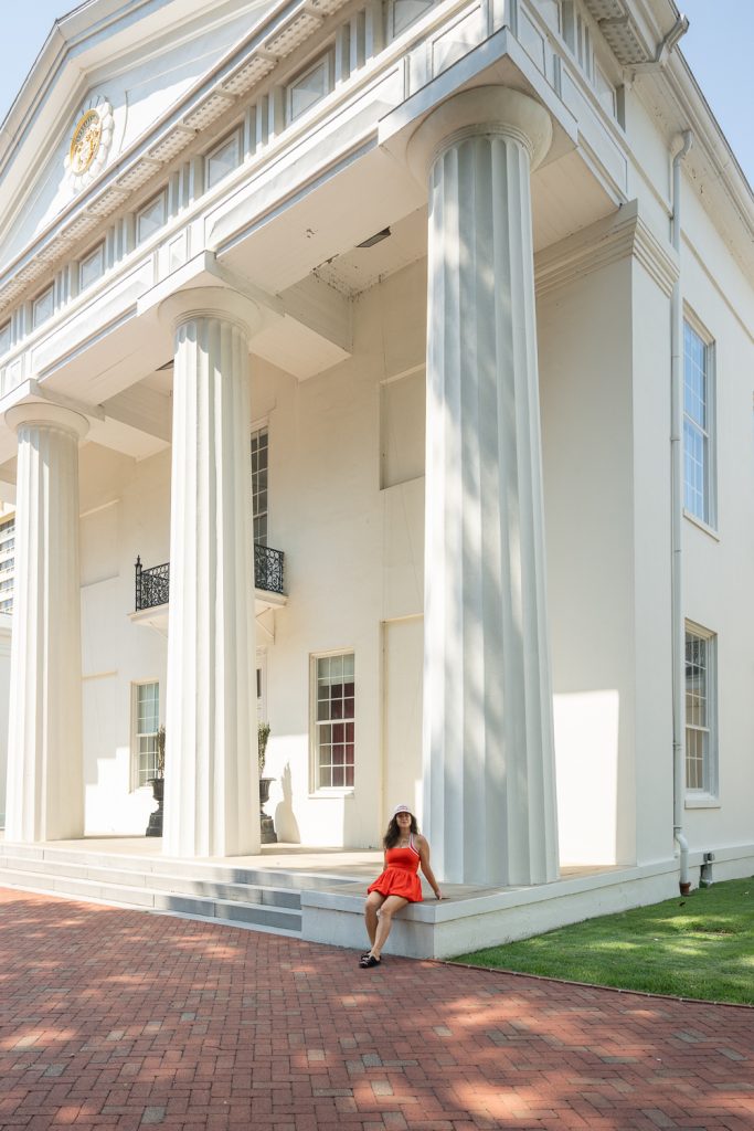 Young woman sitting on the steps of the Old State House Museum in Little Rock, Arkansas.