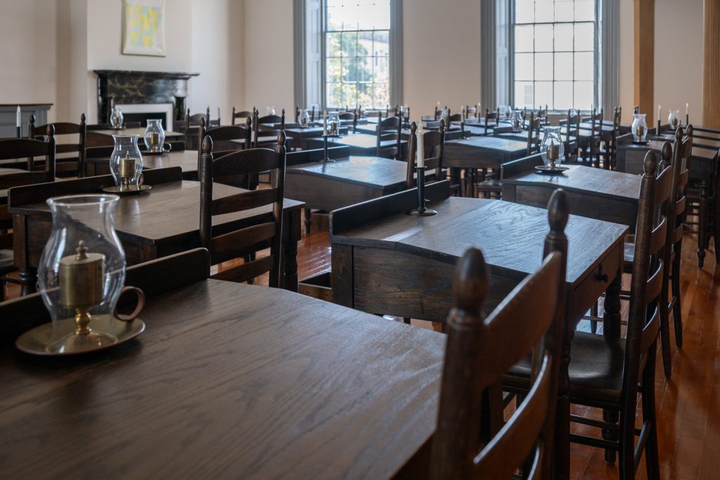 The House of Representatives chamber in the Old State House with rows of wooden desks and chairs.