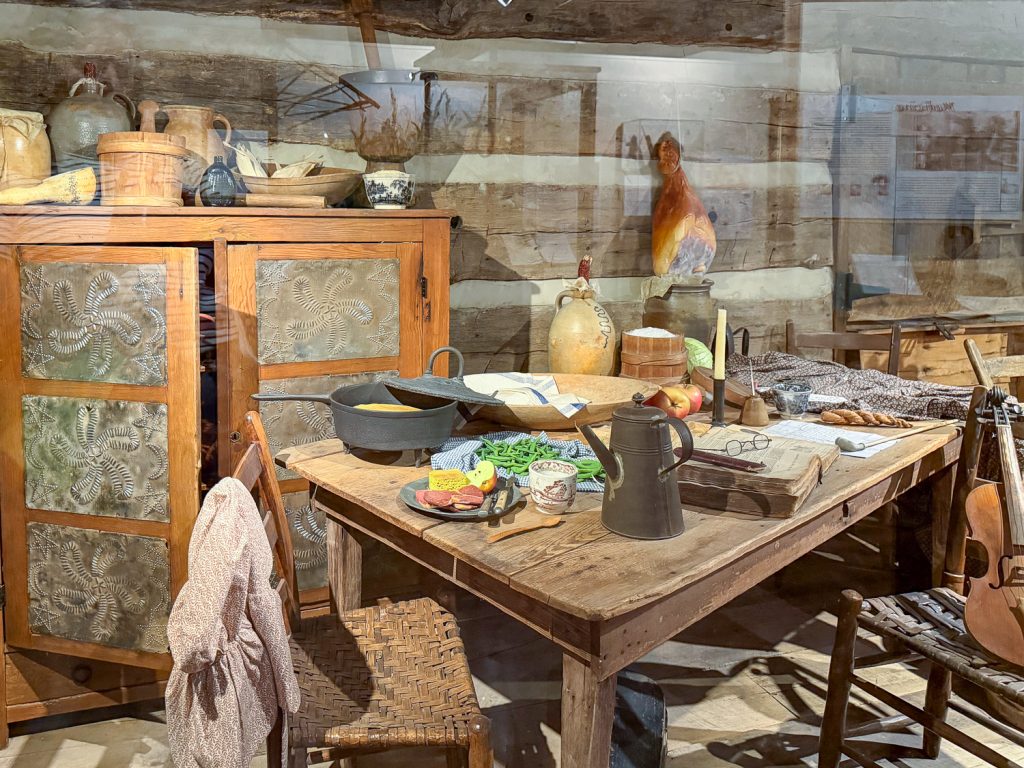 Exhibit of items that might have been in a log cabin in the Arkansas Ozarks during the frontier days.