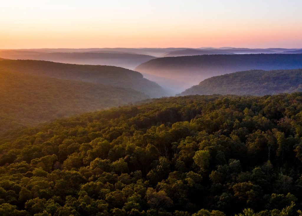 Sunrise view over the Ozark Mountains with fog in the valleys.